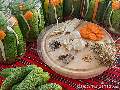 Preparing pickled cucumbers assorted with carrots, garlic, pepper, mustard seeds, celery, dill Stock Photo