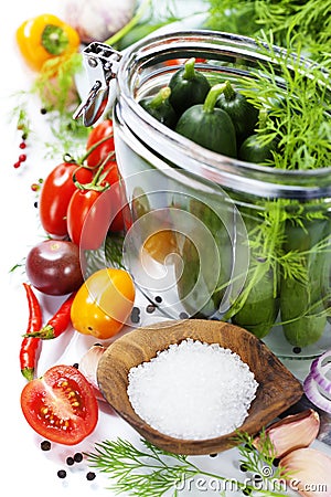 Preparing preserves of pickled cucumbers and tomatoes Stock Photo