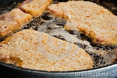 Preparing schnitzel on frying pan Stock Photo