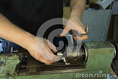 Working on a lathe. Preparing and setting up the machine. Hands of the master Stock Photo