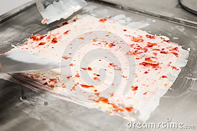 Preparing strawberry rolled ice-cream. Stock Photo