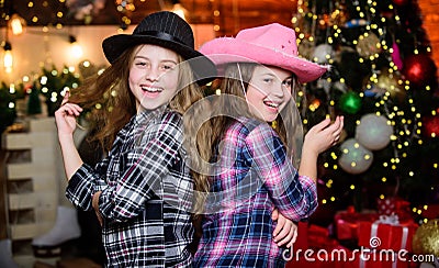 Preparing to Christmas. little girls sisters. Christmas shopping. cowgirl children. Xmas tree. Holiday shopping. Little Stock Photo