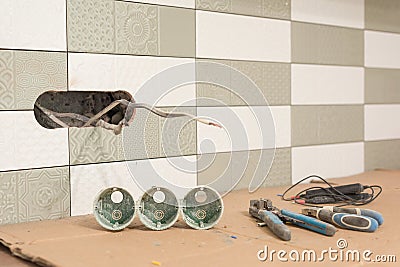 Preparing to install an electrical outlet. Closeup of professional electrician tools and electrical outlets. Renovation and Stock Photo
