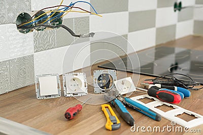 Preparing to install an electrical outlet. Closeup of professional electrician tools and electrical outlets. Renovation and Stock Photo