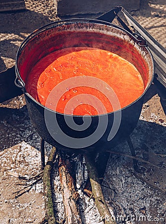 Preparing traditional romanian tomato juice/sause in caldron, bo Stock Photo