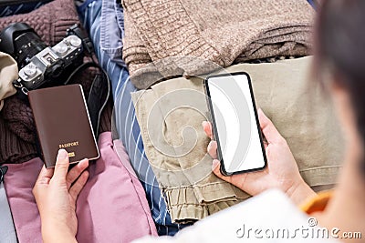 Preparing for travel by searching for information via telephone, equipment used for traveling. Passport and travel. Stock Photo