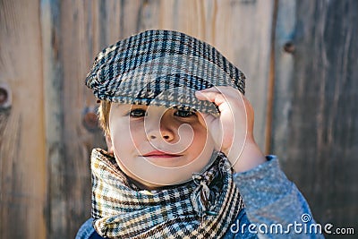 Preschool child. Boy face. Elegant child. Autumn weather. People, adorable kid, funny portrait. Cap, hat and scarf. Stock Photo