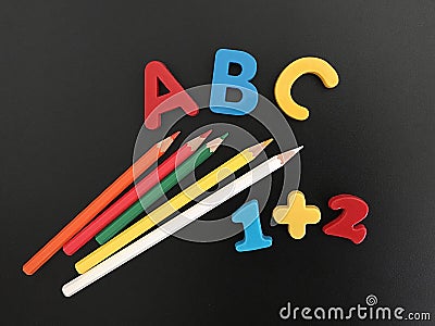 Preschool Education, Colourful Letters, Pencils and Numbers on a Blackboard Stock Photo