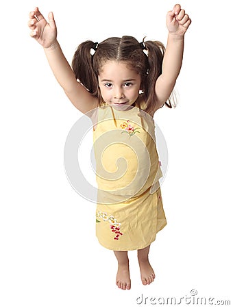 Preschool girl with arms raised above head Stock Photo