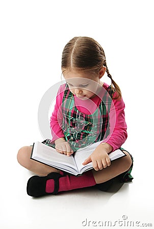 Preschool girl reading Stock Photo