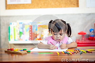 Preschooler child girl drawing and coloring Stock Photo