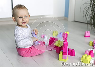 Preschooler child playing with colorful toy blocks Stock Photo