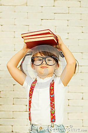 Preschooler girl with books Stock Photo