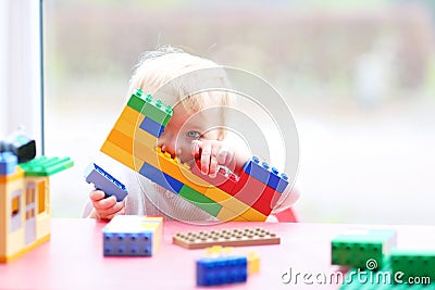 Preschooler girl building from plastic bricks Stock Photo