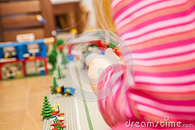 Preschooler girl playing with colorful toy blocks Stock Photo
