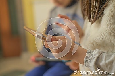 Preschooler Kids playing with portable videogames console,tech kids addiction Stock Photo
