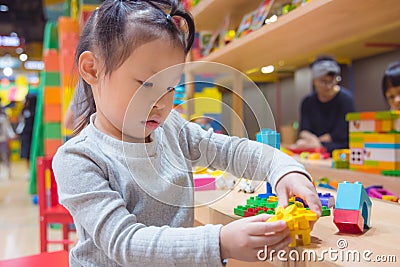 Preschooler playing blocks at school Stock Photo