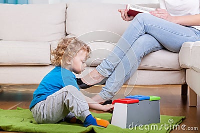 Preschooler playing on the floor Stock Photo