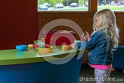 Preschooler playing with play food Stock Photo