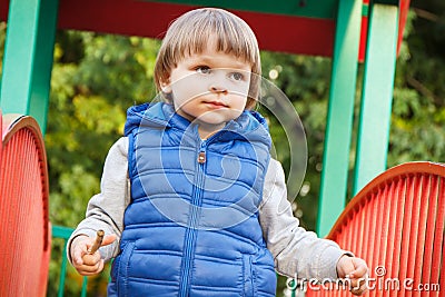 Preschooler playing on playground in park. Child development concept Stock Photo