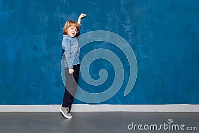 Preschooler showing height on backdrop with Stock Photo