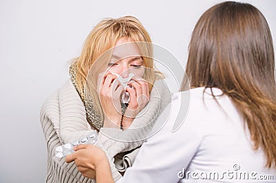 Prescribing physician. Primary care doctor making diagnosis to sick woman. Medical doctor examining patient. Doctor Stock Photo