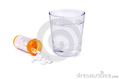 Prescription bottle and pills and glass of water isolated Stock Photo