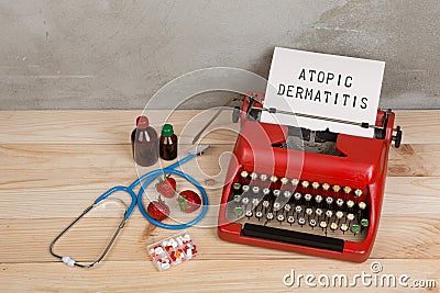 Prescription medicine or medical diagnosis - doctor workplace with stethoscope, pills, typewriter with text Atopic dermatitis, Stock Photo