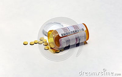 Prescription pill bottle with pills spilling out Stock Photo