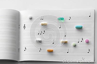 Prescription pills on music paper Stock Photo