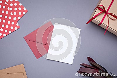 Present card and gift in box with satin ribbon on gray background Stock Photo