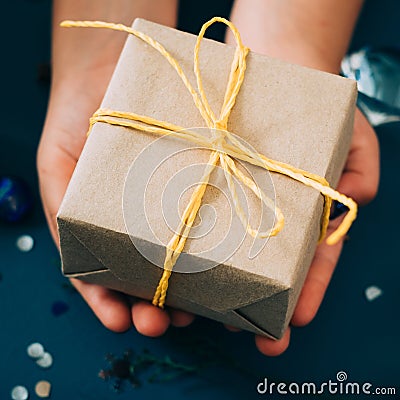 Present craft paper yellow twine hands celebration Stock Photo