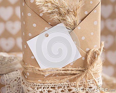 Present with square blank gift tag and pampas grass close up, Rustic label Mockup Stock Photo