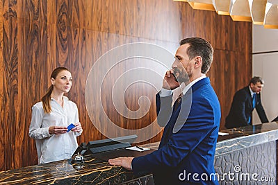 Presentable man standing at reception desk Stock Photo