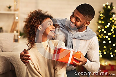 Presenting gift as Christmas eve tradition, celebrating New Year Stock Photo