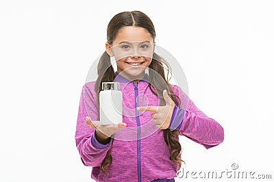 Presenting product. Little child pointing at pill bottle. Small girl with medicine pill and vitamin complex. Adorable Stock Photo