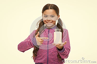 Presenting product. Little child pointing at pill bottle. Small girl with medicine pill and vitamin complex. Adorable Stock Photo