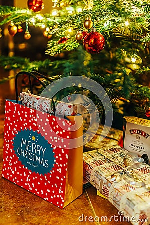 Presents And Chocolate Candies Waiting To Be Opened Under Christmas Tree Editorial Stock Photo