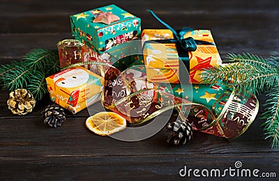 Presents in orange and green paper on the wooden background for friends and family. shopping, New year and Christmas concept Stock Photo