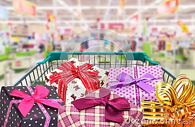 Presents ribbon gift box in shopping trolley cart Stock Photo