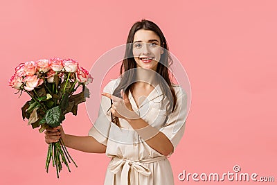 Presents, valentines day, beauty concept. Gorgeous feminine girl florist made beautiful bouquet for customer, holding Stock Photo