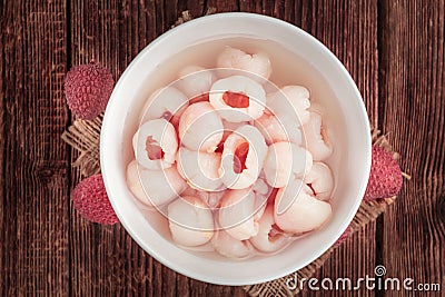 Preserved Lychees selective focus on vintage wooden background Stock Photo