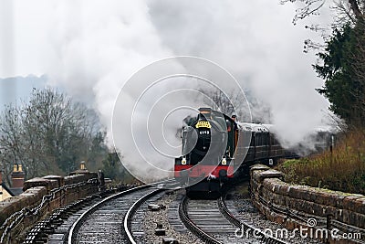 Steam engine arriving at a station Editorial Stock Photo