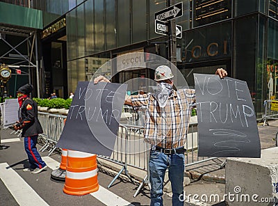 President Donald Trump supporter with signs `Vote Trump` in front of Trump Tower at 5th Avenue in Manhattan Editorial Stock Photo