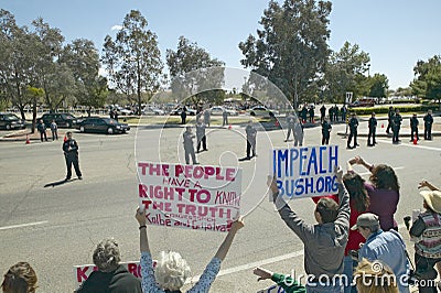 Presidential Motorcade with President George W. Bush past anti-Bush political rally with signs that read Impeach Bush in Tucson Editorial Stock Photo