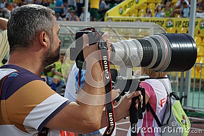 Press photographer at work on a match of the Russian Premier League Kuban-Ufa Editorial Stock Photo