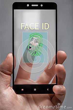 Pressed against the glass is a human face for biometric phone access .the concept of personal data protection Stock Photo