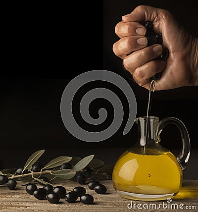 Pressing of olives with hand Stock Photo