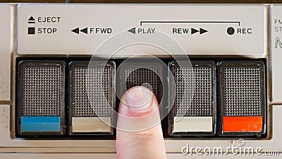 Pressing Play Button on a Retro Cassette Player Stock Photo