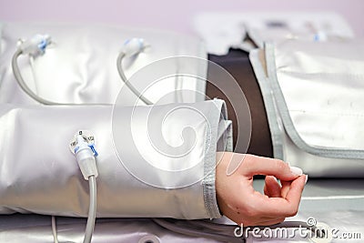 Pressotherapy. Lymphatic drainage massage. Hardware cosmetology. Body care. Anti-cellulite and anti-fat therapy in Stock Photo